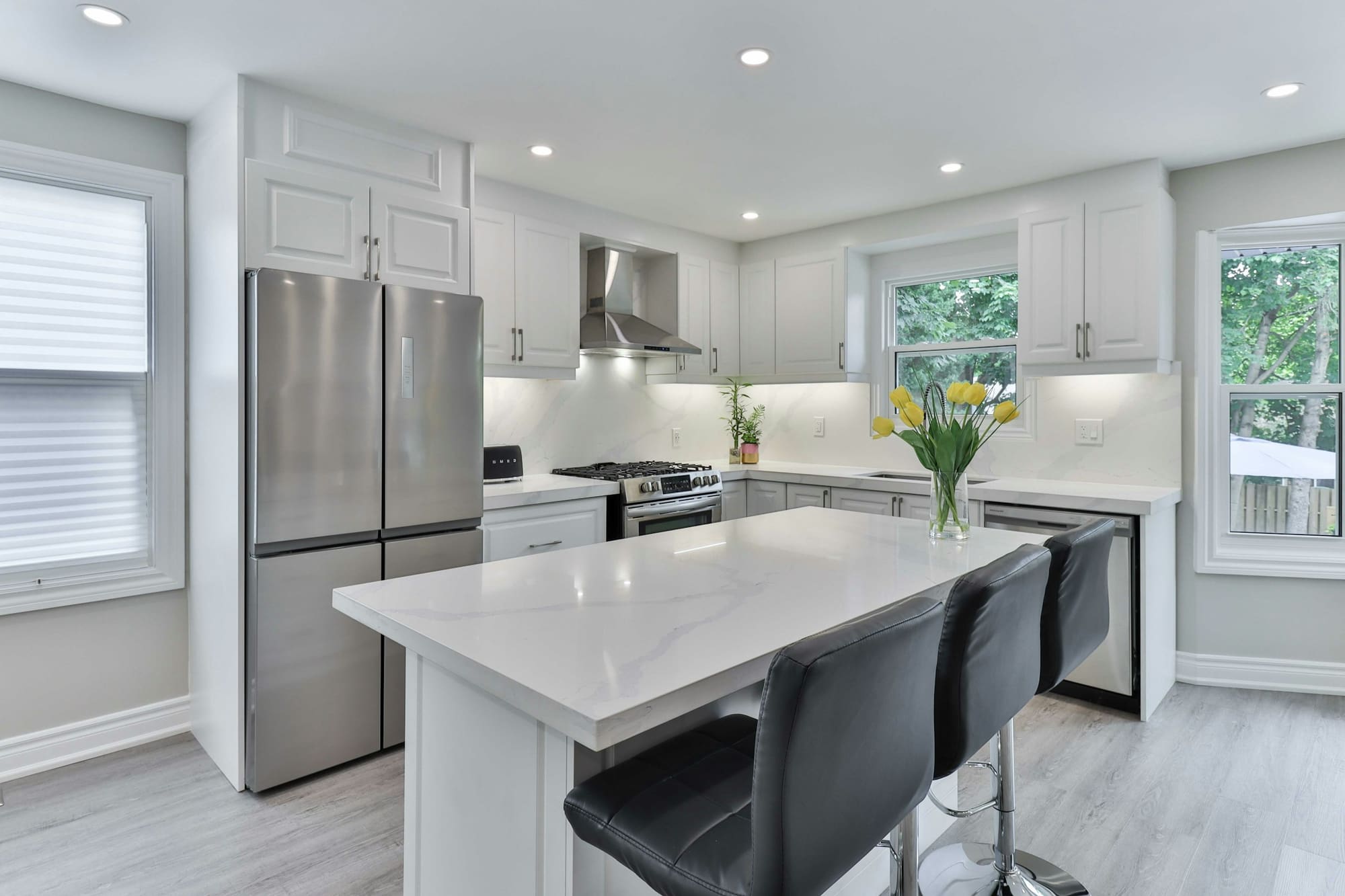 Kitchen with cabinets, counters and appliances around an open workspace