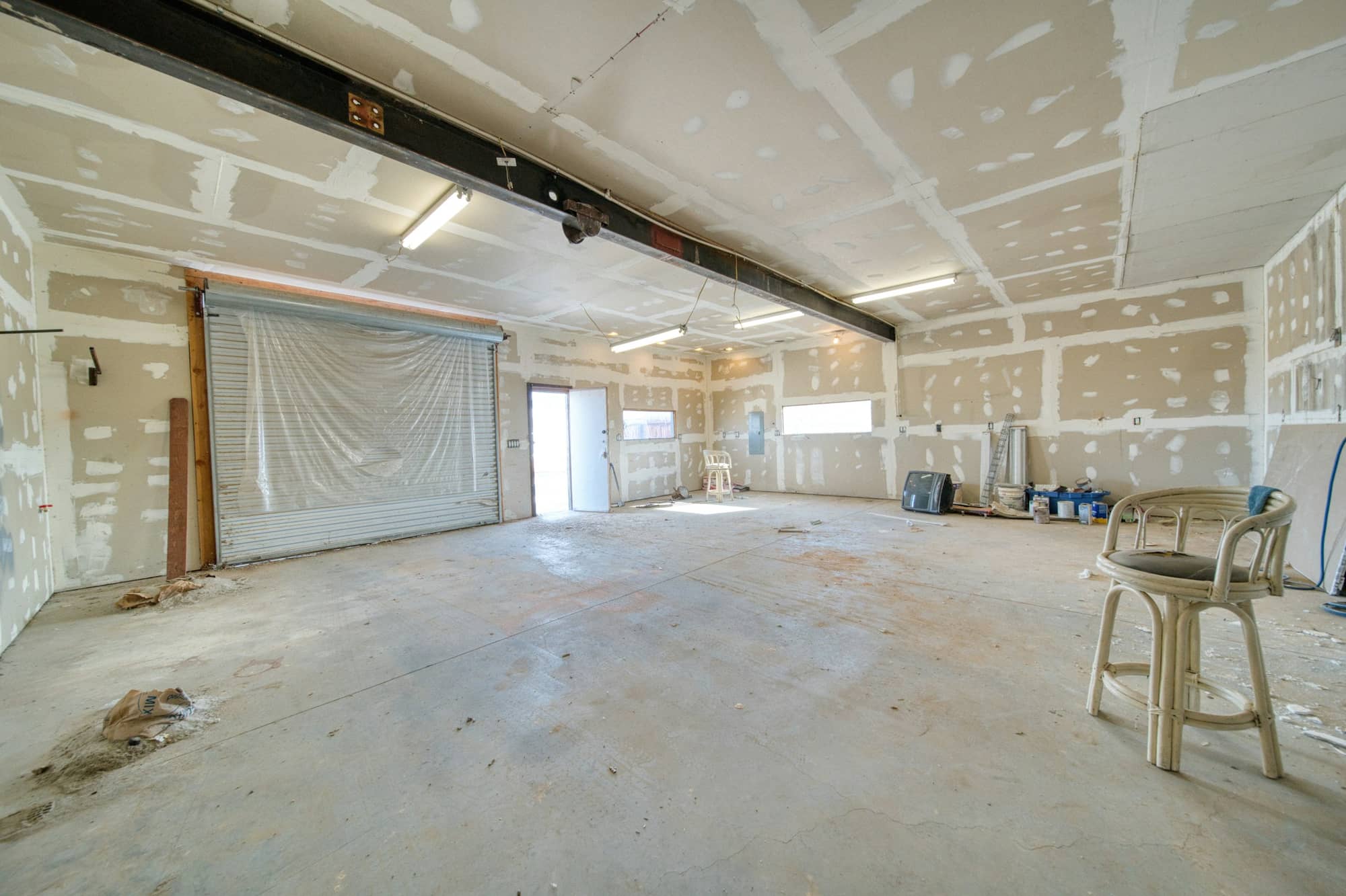 Unfinished room with drywall seams and fasteners covered in joint compound